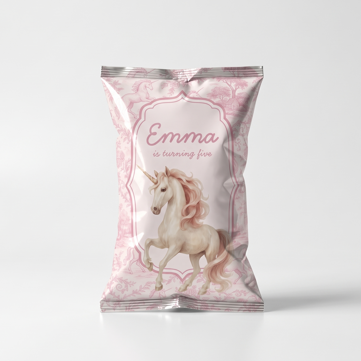 A custom foil snack bag featuring a pink and white unicorn illustration with the text 'Emma is turning five' on a light gray background.