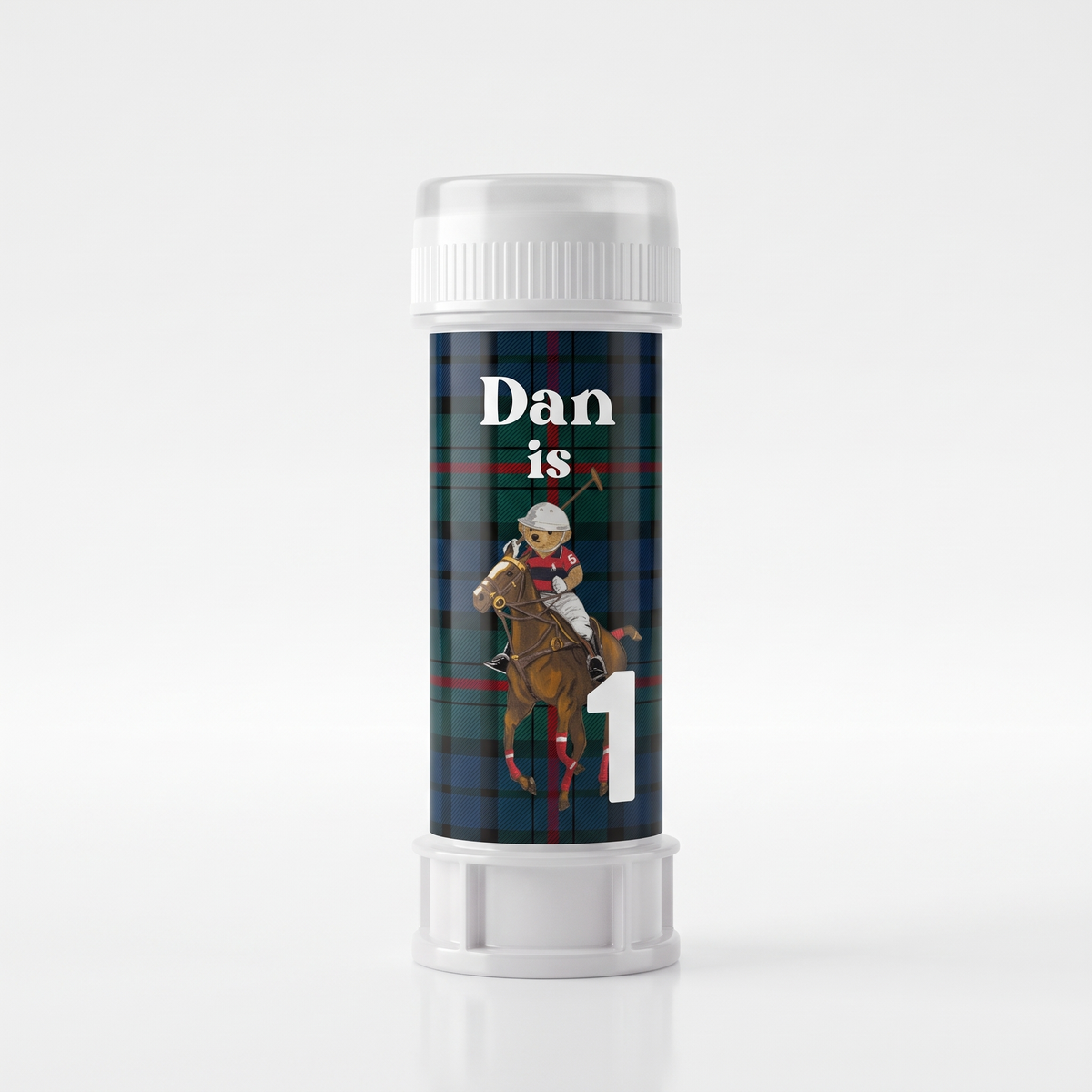 A personalized plastic lip balm tube with a white cap and base, featuring a custom design with a green and blue plaid background, a polo player on a horse, the text 'Dan is', and a large white number '1'.